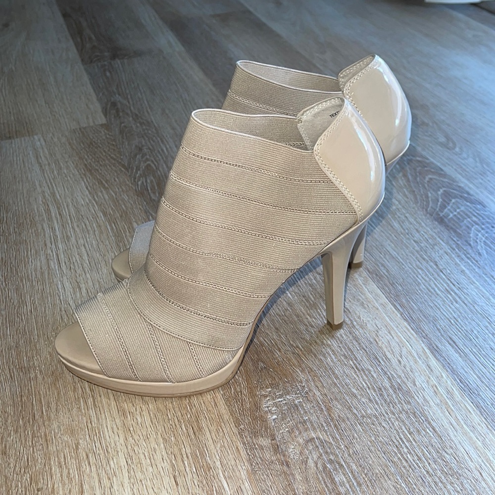 Tan peep toe ankle booties.